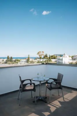 a table and chairs on a balcony with a view at ILIADA Boutique Rooms in Faliraki