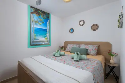 a bedroom with a bed with two teddy bears on it at Malonas Village house in Malona Village