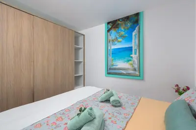 a bedroom with a bed with towels on it at Malonas Village house in Malona Village