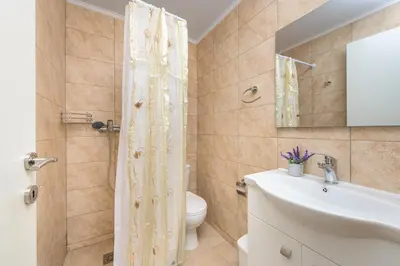 a bathroom with a toilet and a sink and a shower at Malonas Village house in Malona Village