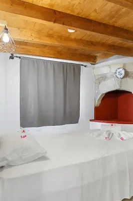 a bedroom with a white bed and a window at VastekaHouse3 in Haraki