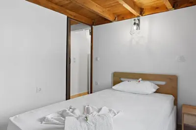 a bedroom with a bed with towels on it at VastekaHouse3 in Haraki