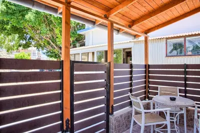 a pergola on a patio with a table and chairs at VastekaHouse3 in Haraki