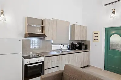 a kitchen with a sink and a stove top oven at VastekaHouse3 in Haraki