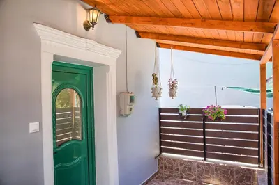 a green door in a room with a balcony at VastekaHouse3 in Haraki