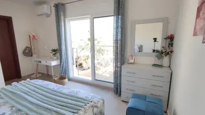 a bedroom with a bed and a dresser and a window at Villa with 2 bedrooms - 2 bathrooms - Private pool in Haraki