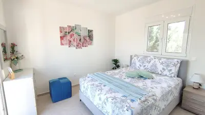 a small bedroom with a bed and a window at Villa with 2 bedrooms - 2 bathrooms - Private pool in Haraki