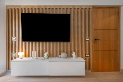 a living room with a tv and a white cabinet at Rhodes center Santa Maria in Rhodes Town
