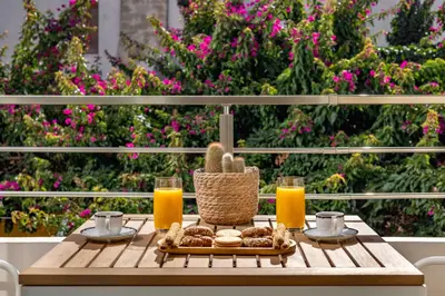 a table with a basket of food and two glasses of orange juice at Rhodes center Santa Maria in Rhodes Town
