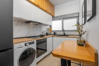 a kitchen with a table and a stove and a dishwasher at Rhodes center Santa Marina in Rhodes Town
