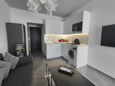 a living room with a couch and a table with wine glasses at Rhodes City Haven in Rhodes Town