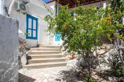 a staircase leading up to a building with a tree at Isminis Villa in Halki