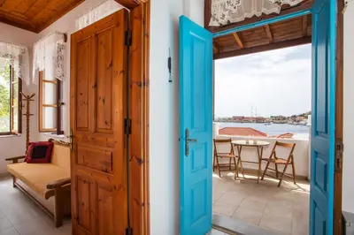 an open door to a room with a table and chairs at Isminis Villa in Halki