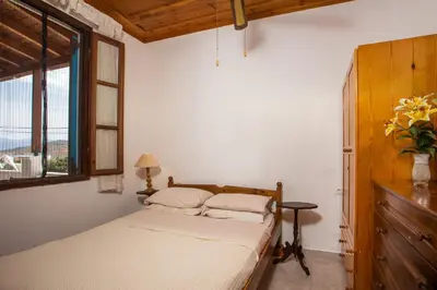 a bedroom with a bed and a window at Isminis Villa in Halki