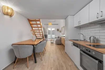 a kitchen with a table and chairs in a room at Rhodes center Santa Mari in Rhodes Town