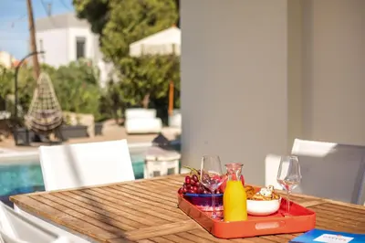 a table with a tray of food and wine glasses at Villa Laila in Ialyssos