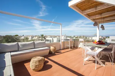 a patio with a couch and a table on a balcony at Villa Laila in Ialyssos