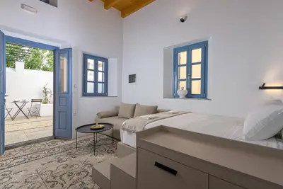 a white bedroom with a bed and a patio at Villa fiore in Rhodes Town