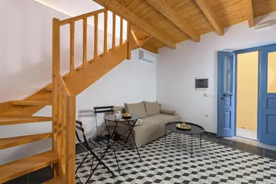 a living room with a staircase and a couch at Villa fiore in Rhodes Town