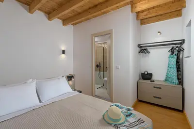 a bedroom with a bed with a hat on it at Villa fiore in Rhodes Town