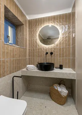 a bathroom with a sink and a mirror at Villa fiore in Rhodes Town