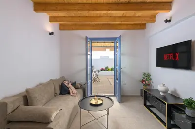 a man laying on a couch in a living room at Villa fiore in Rhodes Town