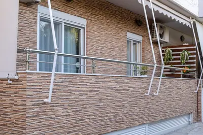 a metal railing on the side of a brick building at Cozy Spot in Ixia
