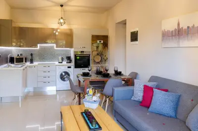a living room with a couch and a table in a kitchen at Cozy Spot in Ixia