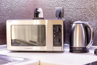 a microwave sitting on top of a kitchen counter at Cozy Spot in Ixia