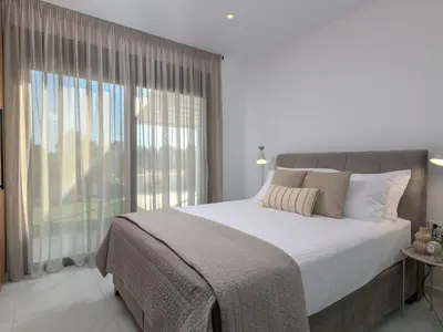 a bedroom with a large bed and a large window at Holiday Home Villa Galini by Interhome in Haraki