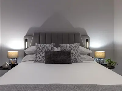 a white bed with pillows and two lamps at Holiday Home Villa Galini by Interhome in Haraki