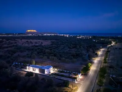 a night view of a building and a road at Holiday Home Villa Galini by Interhome in Haraki