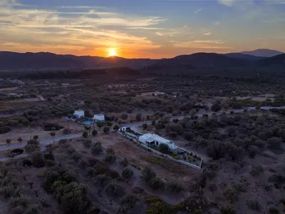 an aerial view of a farm with the sunset in the background at Holiday Home Villa Galini by Interhome in Haraki