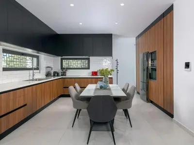 a kitchen with black cabinets and a table and chairs at Holiday Home Villa Galini by Interhome in Haraki