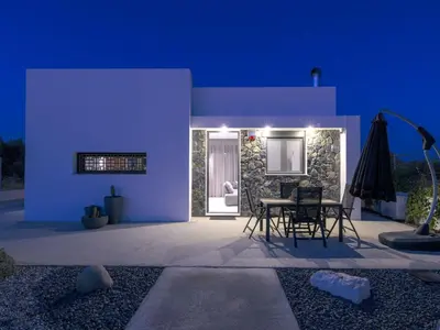 a purple house with a table and a patio at Holiday Home Villa Galini by Interhome in Haraki