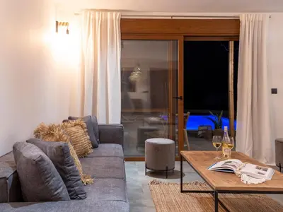 a living room with a couch and a table at Holiday Home Haus in Afantou - Privater Parkplatz und Pool by Interhome in Afantou