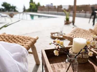 a table with a candle and flowers on a patio at Holiday Home Haus in Afantou - Privater Parkplatz und Pool by Interhome in Afantou