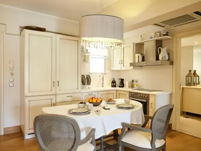 a kitchen with a white table and chairs and a table and chairsktop at Apartment Einzigartige Wohnung auf Rhodos by Interhome in Rhodes Town
