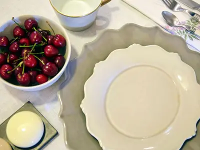 a table with a plate and a bowl of cherries at Apartment Einzigartige Wohnung auf Rhodos by Interhome in Rhodes Town