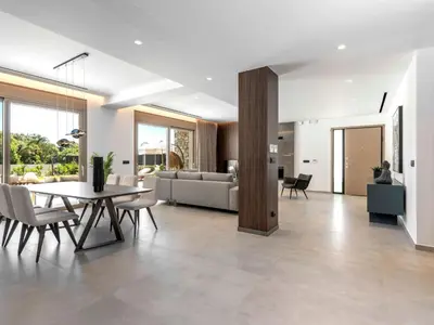 a living room with a table and a couch at Holiday Home Emerald Estate by Interhome in Asgourou