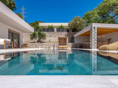 a swimming pool in the backyard of a house at Holiday Home Emerald Estate by Interhome in Asgourou