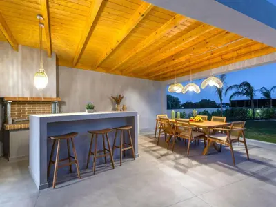 a kitchen and dining room with a table and chairs at Holiday Home Emerald Estate by Interhome in Asgourou