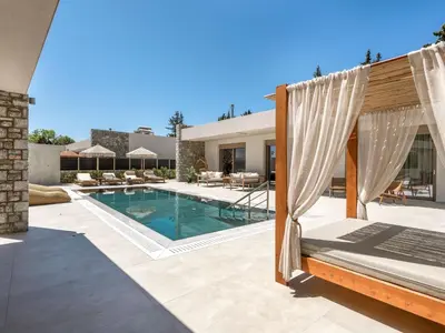 a backyard with a swimming pool and a house at Holiday Home Emerald Estate by Interhome in Asgourou