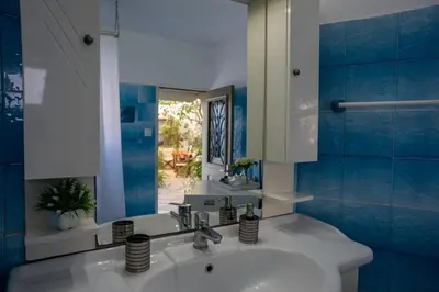 a bathroom with a sink and a mirror at Hermes Traditional house in Gialos in Symi