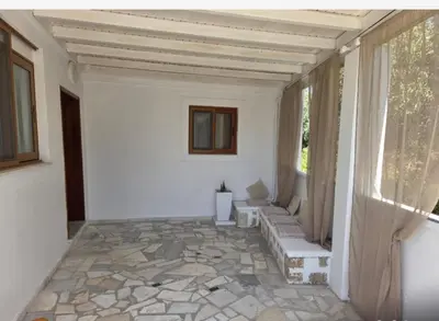 a living room with a stone floor and a window at Eirēnē house Afantou in Afantou