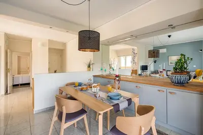 a kitchen and dining room with a table and chairs at Russelia Suite right in the heart of Rhodes City in Rhodes Town