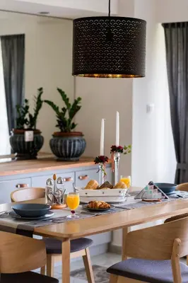 a dining room table with a plate of food on it at Russelia Suite right in the heart of Rhodes City in Rhodes Town