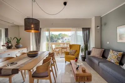 a living room with a couch and a table at Russelia Suite right in the heart of Rhodes City in Rhodes Town