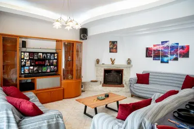 a living room with two couches and a fireplace at Golden Grove in Afantou