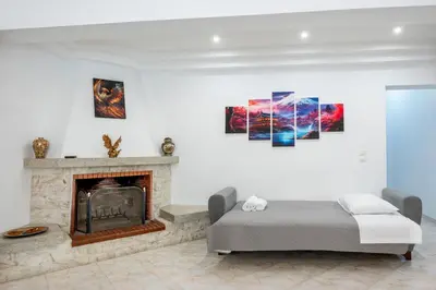 a bedroom with a bed and a fireplace at Golden Grove in Afantou